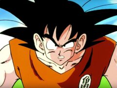 Goku in his orange gi gritting his teeth against a blue sky in a Dragon Ball Z anime still